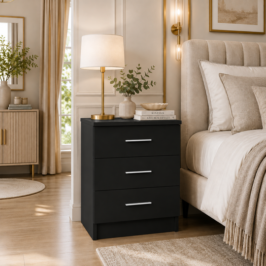 Valencia black 3 drawer bedside chest with silver handles styled beside a bed