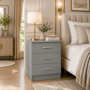 Valencia grey 3 drawer bedside chest with silver handles in a modern bedroom